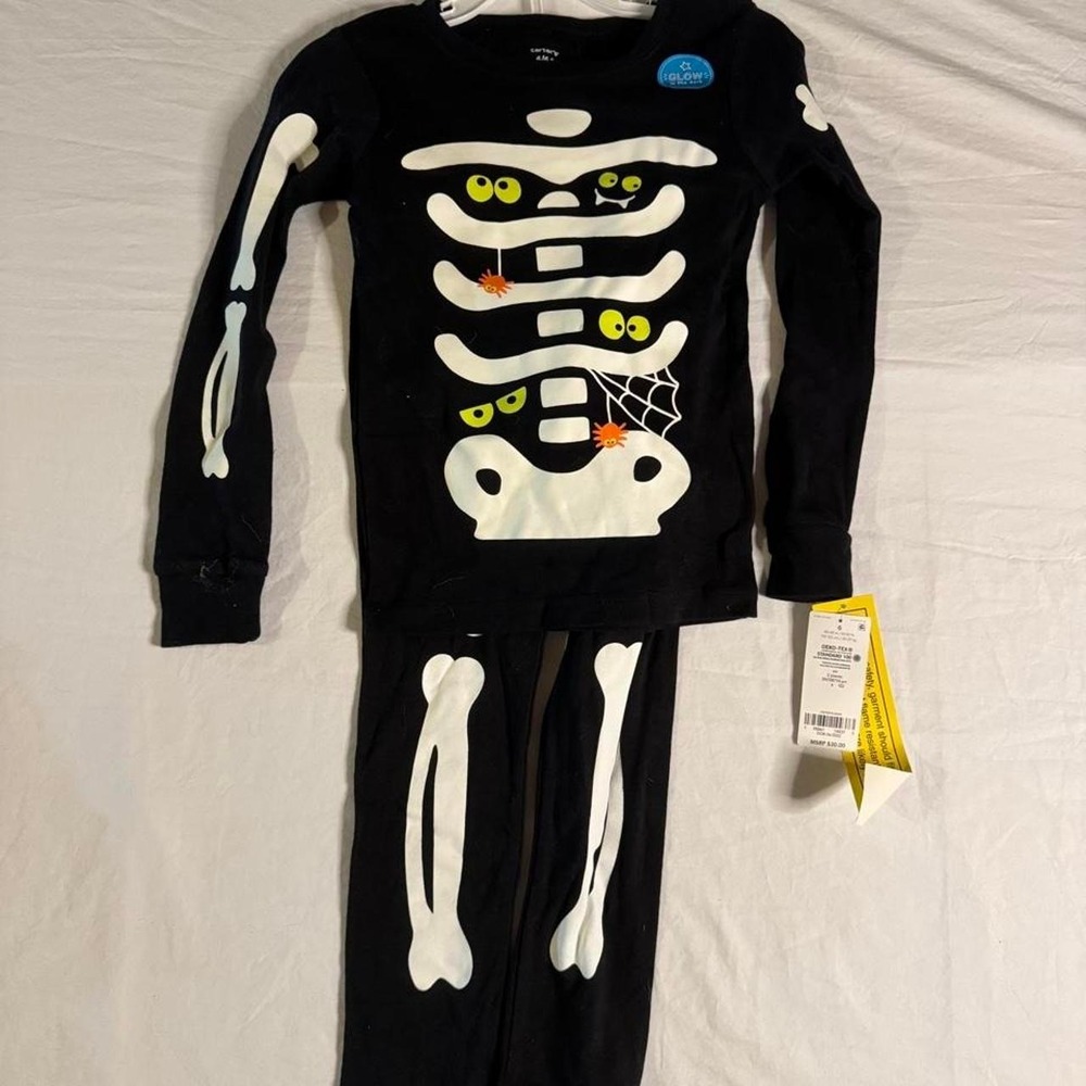 Carter's black skeleton pajama set with glow in the dark details